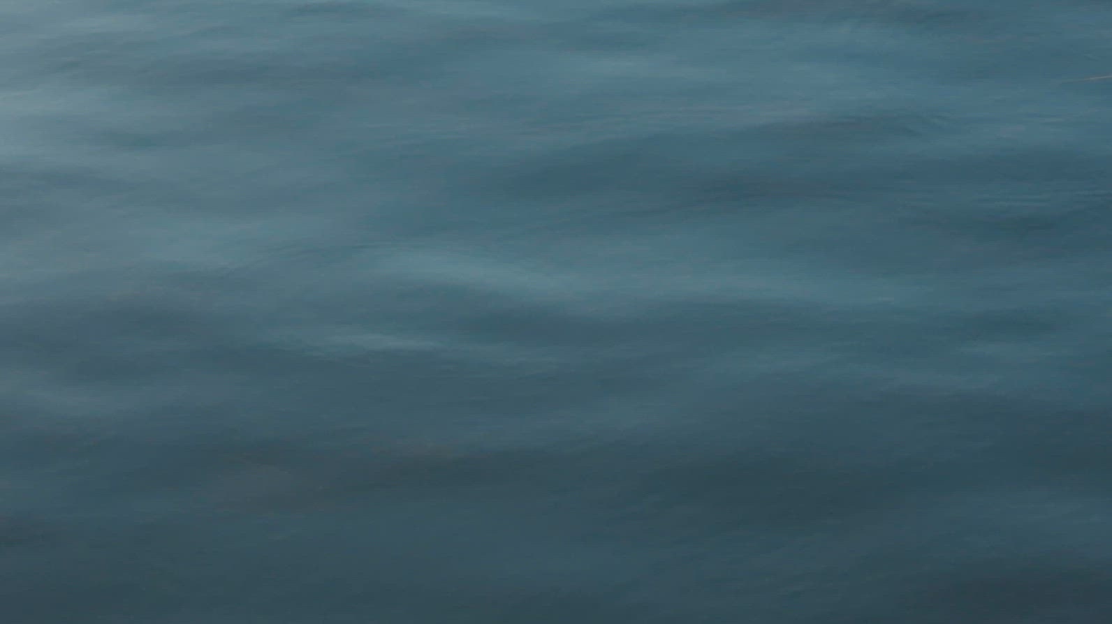 Seamless loop calm blue water surface with gentle ripples